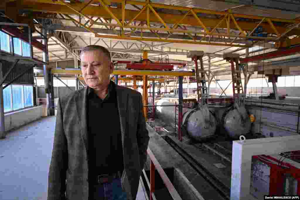 Ion Ignat, the founder and director of the company producing building materials, contemplates his future at the idled factory that previously employed 50 workers. 