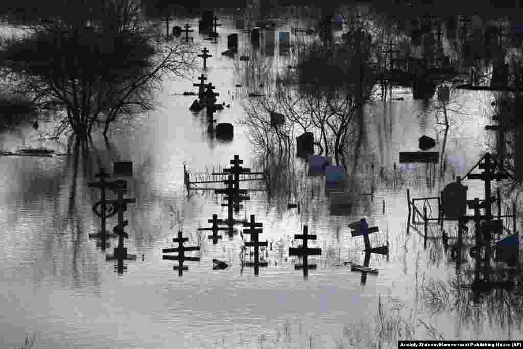 Crosses stand above the floodwaters in a cemetery in Orsk. Regional authorities said they found four people dead in the flood zone. The authorities said two died of heart attacks and one committed suicide. The cause of the fourth death was not specified, but was designated as "natural," state-owned RIA Novosti reported.