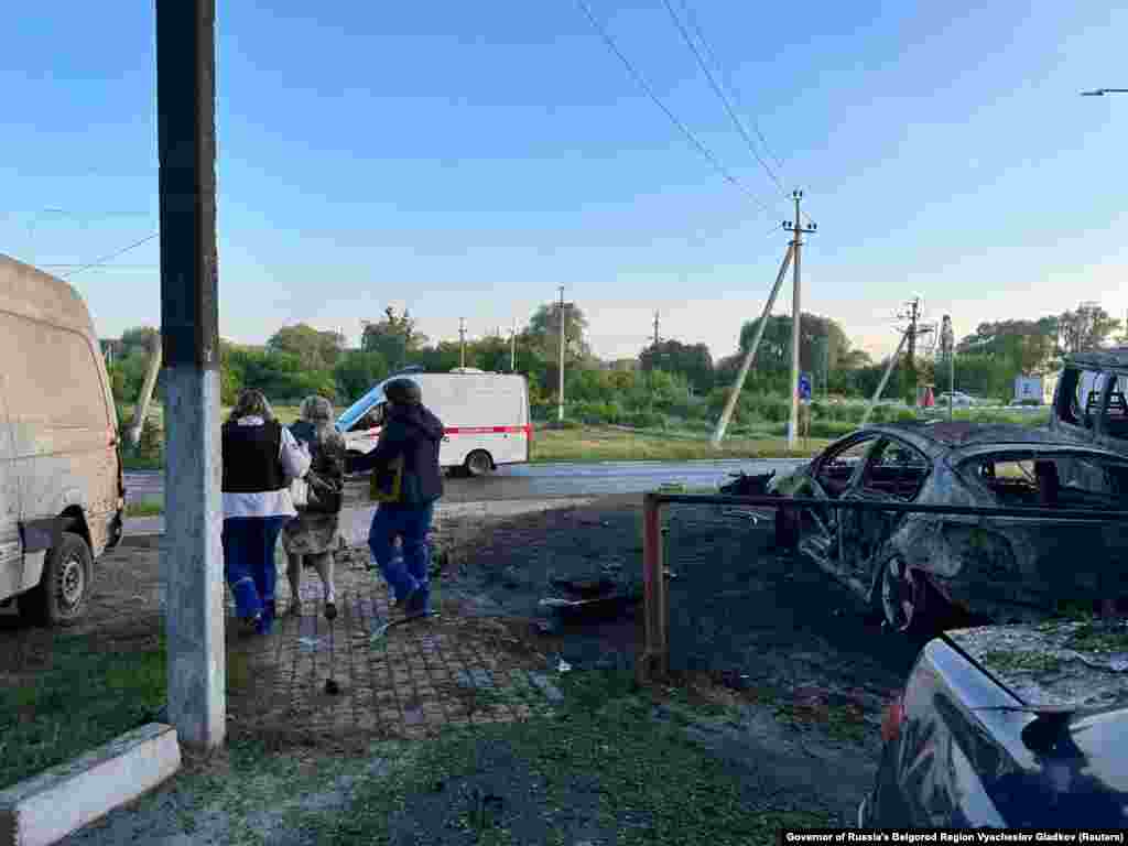 A woman is led away by two people wearing paramedic uniforms in Shebekino. Gladkov said on Telegram that at 3:15 a.m. on May 31 "Grad shells" injured four people, with one man suffering serious wounds from shrapnel. RFE/RL is not able to verify the claims. 