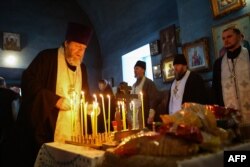 A church service is held on January 24 for those killed in the Il-76 incident in the village of Yablonovo, near the crash site.