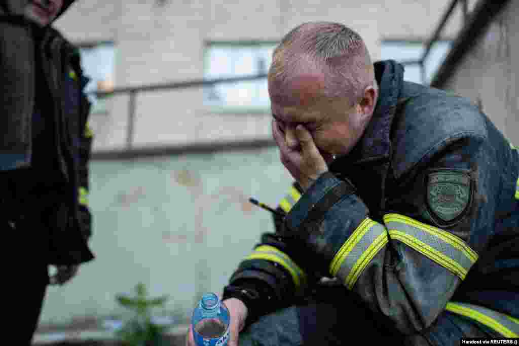 A firefighter reacts on the scene of the drone attack on the apartment building. The attack was the 17th on Kyiv in May. 