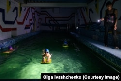 Children attend a swimming class during a blackout in Kharkiv on April 8.