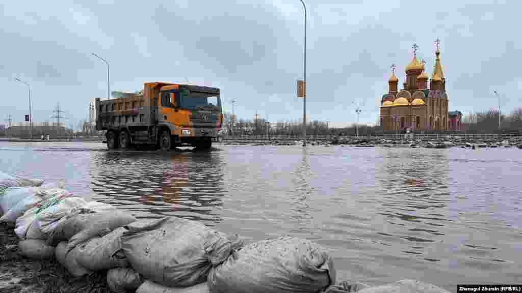 A truck drives through a flooded street in the city of Aqtobe. Officials said the massive floods were triggered by an abrupt period of warm weather that led to a huge snowmelt.