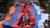 Armenia - People carry giant Armenian and Russian flags as they mark the 78th anniversary of Soviet victory over Nazi Germany, May 9, 2023.