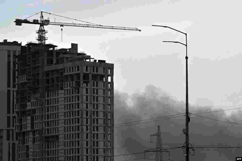 Smoke billows from a Russian missile strike in Kyiv. At least two people were injured in a strike on Kyiv's Sviatoshyn district, Mayor Vitali Klitschko wrote on Telegram.
