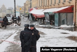 Police officers stand guard at the scene of the explosion.