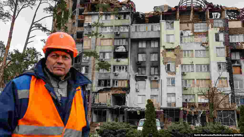 A construction worker looks on in a damaged residential area of Irpin on April 4. Irpin's reconstruction is expected to cost about $685 million, according to ReBuildUA. 