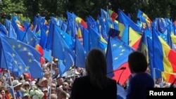 Președinta Parlamentului European, Roberta Metsola, și președinta Republicii Moldova, Maia Sandu, privesc participanții de la mitingul de susținere a parcursului european al țării, în Chișinău, pe 21 mai 2023.