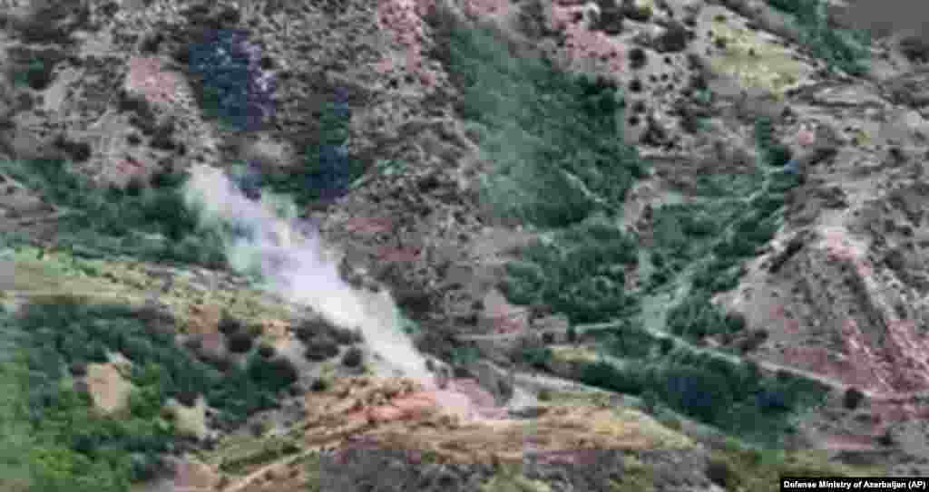 Smoke rises over an area that Azerbaijan claims hosts ethnic Armenian forces' positions in the breakaway territory of Nagorno-Karabakh on September 19. The expected halt in intense fighting in the decades-old Caucasus hot spot comes as international fears of a widening conflict mounted and as the death toll increased in the deadliest military escalation there in nearly three years.