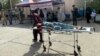 An injured Afghan man is brought to a hospital following an earthquake in Herat Province earlier this month.