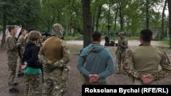Новобранці 3-ї десантно-штурмової бригади слухають вказівки інструктора. Київ, червень 2023 року