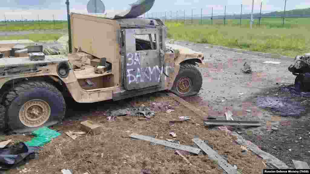 A damaged vehicle with "For Bakhmut" spray-painted on its door is seen in a video grab from footage believed to have been taken inside Russia on May 23. The raid into Belgorod was reportedly launched by the Russian Volunteer Corps and the Free Russia Legion. Both groups are made up of ethnic Russians who have fought alongside the Ukrainian military against the Russian invasion.