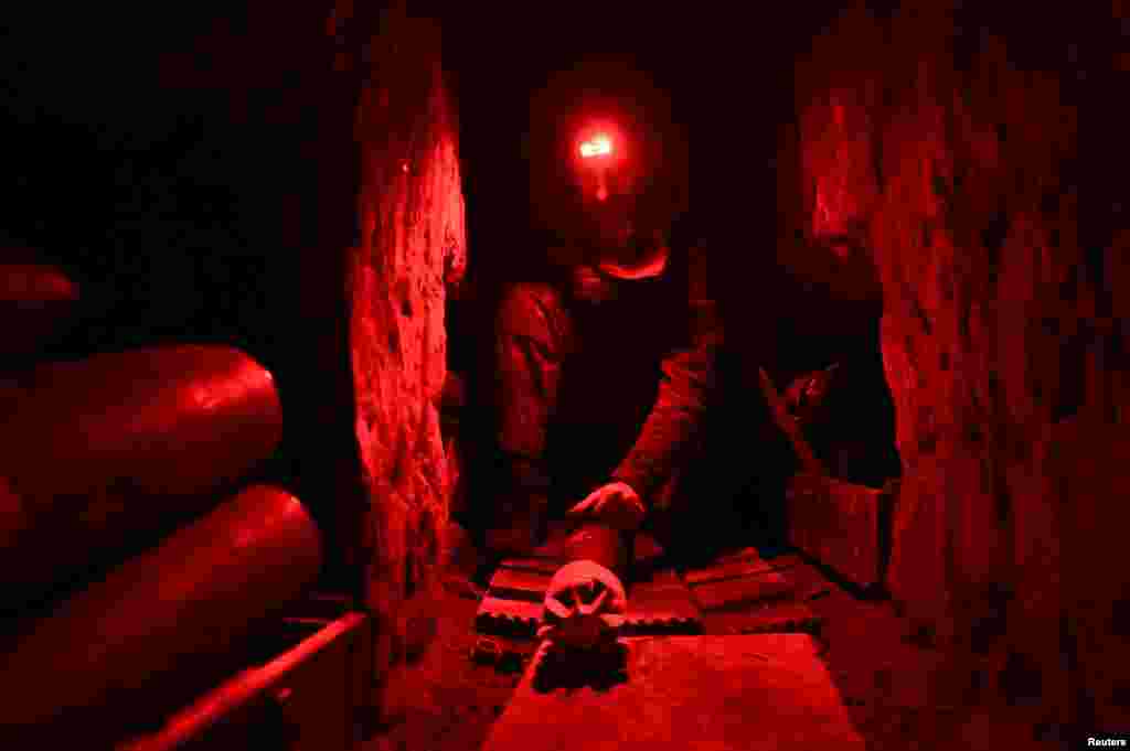 A Ukrainian soldier checks a mortar shell inside a dugout at an undisclosed location in the Donetsk region on October 7. The Ukrainian military has claimed some success in its operations in the eastern and southern regions of Donetsk and Zaporizhzhya.