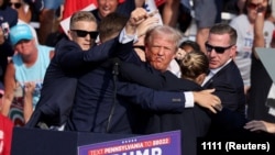 Donald Trump pumps his fist after a failed attempt on his life during a rally in Pennsylvania on July 13.