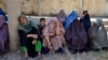Afghan women wait to receive food from foreign aid in Kandahar. Since seizing power in August 2021, the Taliban has reinstated one of the most rigid gender discrimination policies in the world.