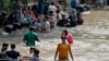 People cooling off on a sweltering afternoon in Lahore on May 19. 