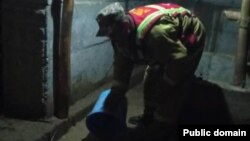 A Kyrgyz man clears water from a flooded house in Jalal-Abbad on April 21.