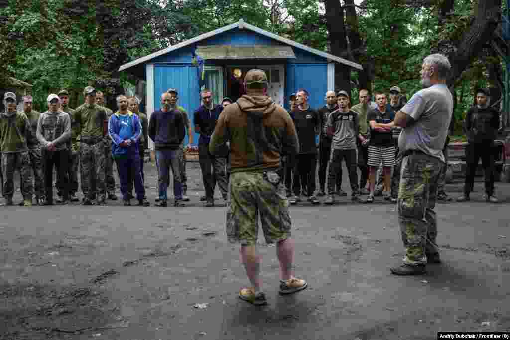 "No one will send you like lambs to the slaughter. We care about our people," the unit commander tells recently released prison recruits as they arrive for military training. 