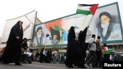 An Iranian woman in Tehran holds a Palestinian flag during a rally in support of Palestinians on October 13.