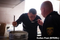 Andriy Talanov and Viktor Veretelnyk sample the okroshka they are making during downtown at Kharkiv's main fire station.