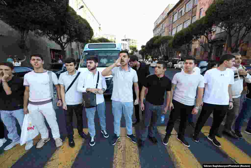Protesters block a road near the government building in Yerevan on September 19. Angered by what they saw as Moscow's failure to stop Azerbaijan, demonstrators also gathered outside the Russian Embassy in Yerevan, chanting anti-Russian slogans, TASS reported. 