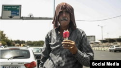 An Iranian man eats a popsicle amid soaring temperatures in many parts of the country.