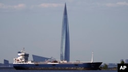 An oil tanker in the Gulf of Finland passes the Lakhta Center skyscraper, the headquarters of Russian gas monopoly Gazprom, in St. Petersburg, Russia, in June 2023.