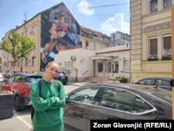 Artist Marija Soln near her mural of Gina Ranjicic at Solunskoj 18 in Belgrade