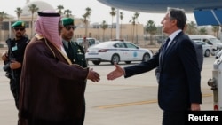 U.S. Secretary of State Antony Blinken (left) is welcomed by Saudi officials on a visit to Riyadh during a Gaza diplomacy push late last month. 