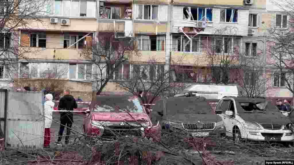 The aftermath showing blown out windows at a residential home.