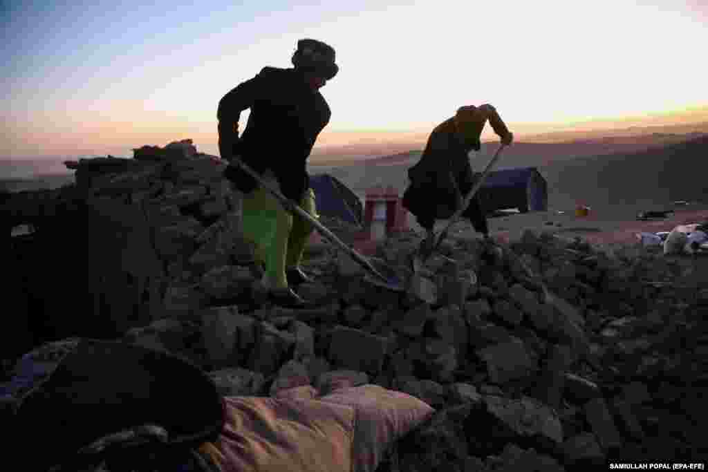 Men search for belongings to salvage as the day turns to night. The U.S. Geological Survey recorded the largest of the earthquakes at a magnitude of 6.3, with the latest aftershock coming about 30 kilometers northeast of the city of Zindah Jan, which has a population of about 70,000 people.