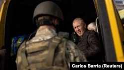 A local resident is seen a during an evacuation effort at a bus station in the outskirts of Kherson on May 4.