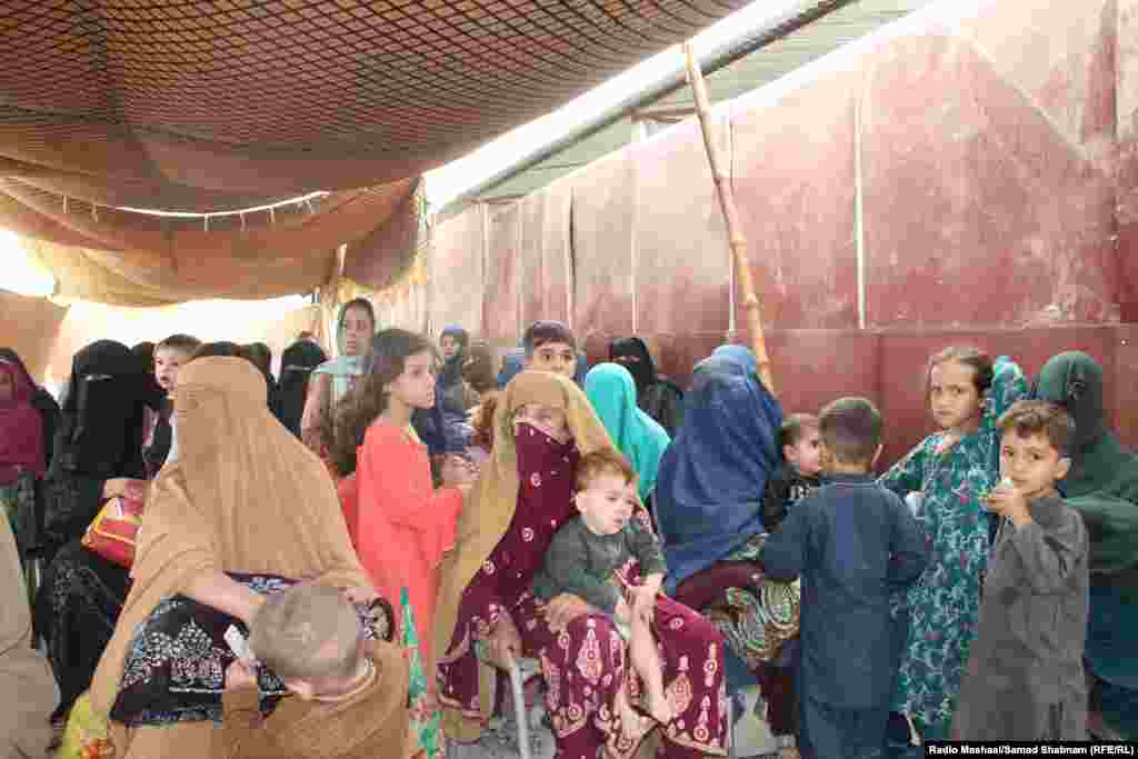Afghan women and children wait at the center. Aid agencies warned that the mass movement of people could tip Afghanistan into yet another crisis and expressed "grave concerns" about the survival and reintegration of the returnees, particularly with the onset of winter.