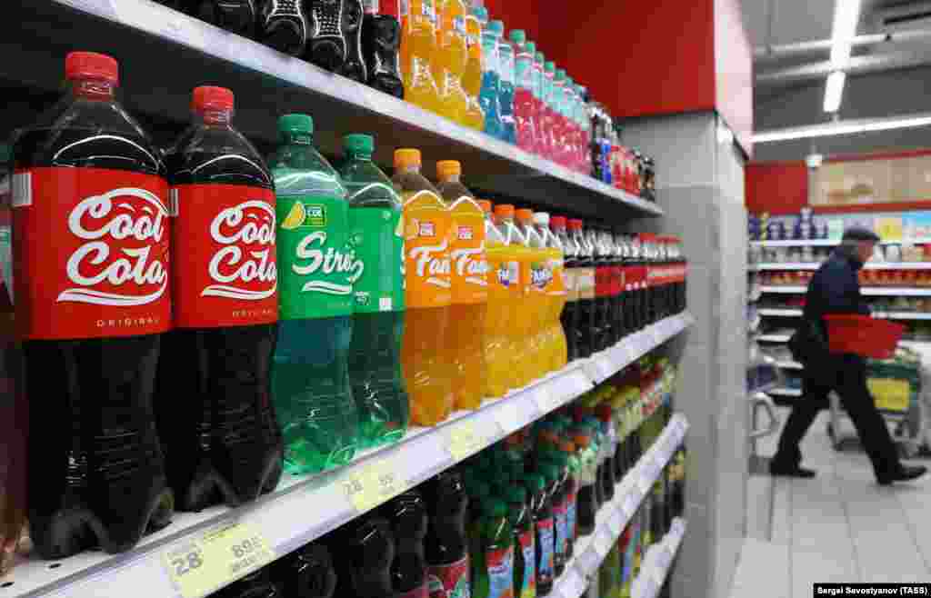 Coca-Cola stopped production and sales in Russia in August 2022, leading to a flurry of similar drinks being produced domestically to fill the gap in the local market. This photo shows Russian-made Cool Cola, Street, and Fancy drinks on sale at a grocery store in Moscow. 