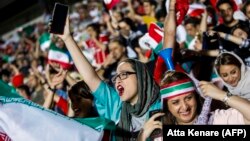 Iranian female soccer supporters were given a rare opportunity to cheer their team on at a special live transmission in Tehran of their country's World Cup game with Spain on June 20.