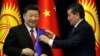 Kyrgyz President Sooronbai Jeenbekov (right) awards Chinese President Xi Jinping with the Manas Order at a meeting in Bishkek in June 2019. 
