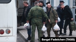 Mobilized men board a bus outside a temporary mobilization station set up at Moscow's Roman Viktyuk Theater at the end of September.