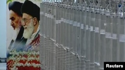 A poster of Supreme Leader Ayatollah Ali Khamenei (right) and the late Ayatollah Ruhollah Khomeini is seen next to a bank of centrifuges in what is described by Iranian state television as a facility in Natanz, where the country has long had a uranium-enr