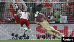Poland's Robert Lewandowski (left) scores the first goal of Euro 2012 in the opening match against Greece.
