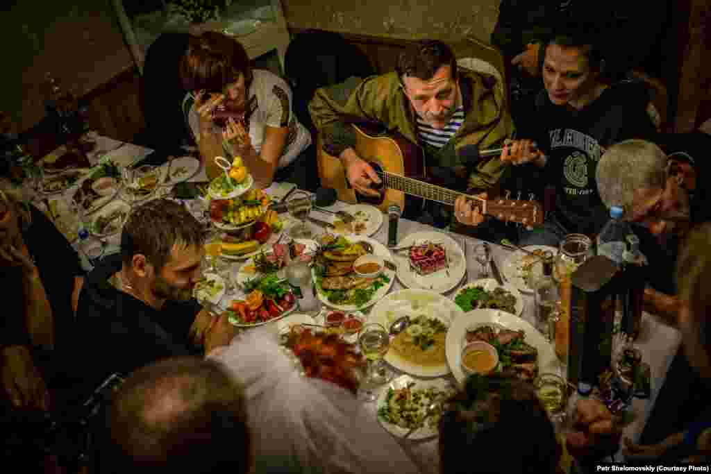 Rebel field commander Igor Bezler, who is known to his comrades as "Bes," plays guitar at the wedding of one of his unit members in Gorlovka, in the Donetsk region.