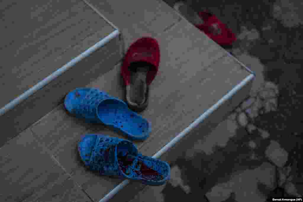 Blood-spattered slippers sit outside a house at the site of the shelling. Following the withdrawal of Moscow's forces across the Dnieper River, Russian artillery continues to indiscriminately maim and kill residents of Kherson.
