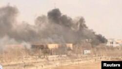 Clouds of smoke rise from the Kazakh town of Zhanaozen in December 2011 in a still image taken from video acquired by Reuters TV.