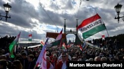 People attend a pro-government rally in Budapest during a commemoration of the 65th anniversary of the 1956 Hungarian Uprising on October 23. 