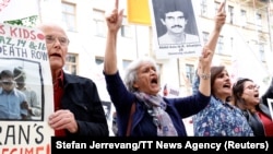 Mujahedin-e Khalq Organization supporters protest in August 2021 outside a Stockholm court on the first day of the trial of Hamid Noury, accused of involvement in the massacre of political prisoners in Iran in 1988.