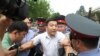 Задержанный сотрудниками милиции участник акции "Тезекпром". 