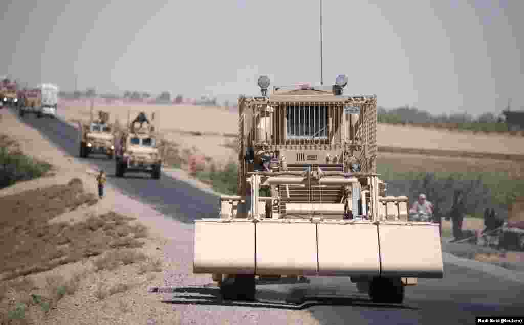 A U.S military demining vehicle leads a convoy near Raqqa in July 2017. 