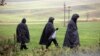 Police officers walk near the site of an explosion in Przewodow, a village in eastern Poland near the border with Ukraine, on November 16. 