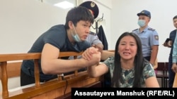 Bayan Shyrynbekova (right), whose husband Alibek Imanbekov (left) was sentenced to six years in prison on a charge of stealing firearms from a store in Almaty during the unrest, says he had to sign a written confession after he was "beaten and tortured" by investigators.