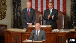 Afghan President Ashraf Ghani (center) is applauded by House Speaker John Boehner (right) and Vice President Joe Biden (left) as he arrives to addresses a joint session of Congress at the U.S. Capitol in Washington in 2015.