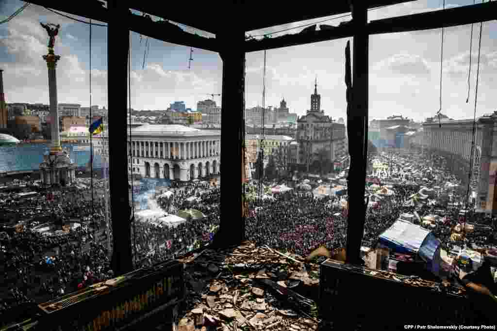 Second Prize, Spot News: A burned-out building's broken windows open onto Kyiv's Independence Square. (Petr Shelomovskiy)